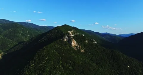 Large Rock Formation On Top Of Mountain Ridge Rhodopes Europe Bulgaria Aerial Stock Footage 289415249