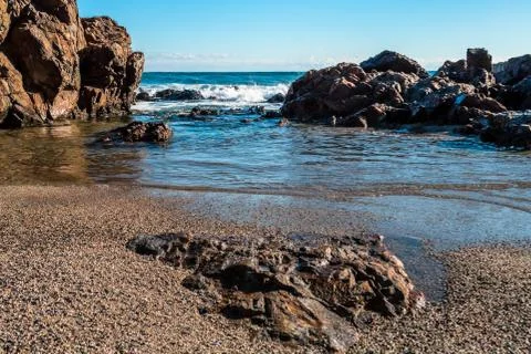 Large rock formations on beach Stock Photos