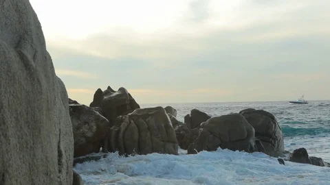 Large rock formations on Mexican beach with water crashing into rocks A Stock Footage 120368074