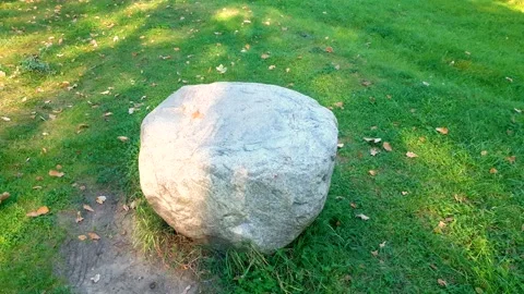 A large rock on the grass. Natural stone in nature. Stone, a signpost path. Stock Footage 288113818