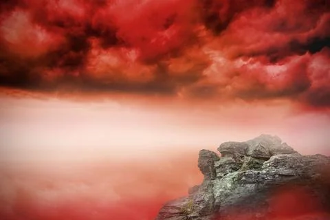 Large rock overlooking red sky Stock Illustration