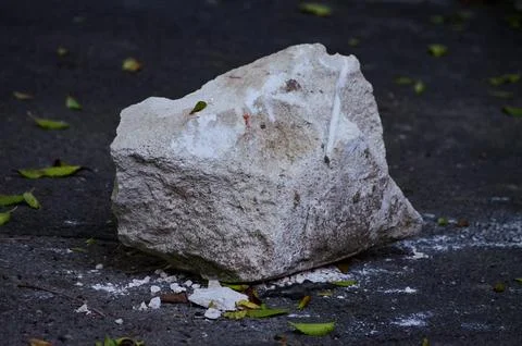 A large rock is sitting on the ground Stock Photos