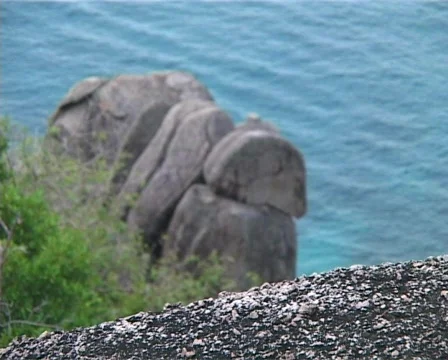 Large rock surrounded by clear green ocean 스톡 동영상 502614