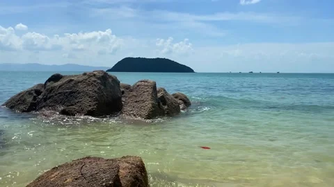 Large rocks appeared out of the water at low tide. Stock Footage 230083576