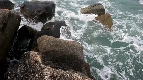 Large rocks break the incoming waves. Stock Footage 230079125