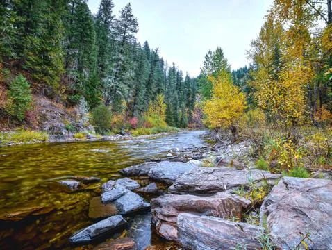 LArge rocks by a mountain stream in fall. Stock Photos
