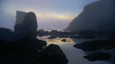 LARGE ROCKS IN THE OCEAN – SUNSET (PAN) Stock Footage