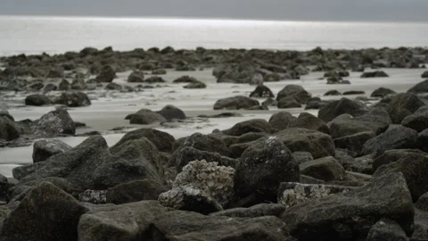 Large Rocks Piled Up on Ocean Shore Stock Footage 306667032