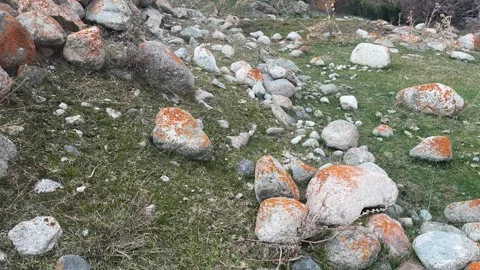 Large rocks rolling down grassy mountain slope among scattered stones and 스톡 동영상 336960245