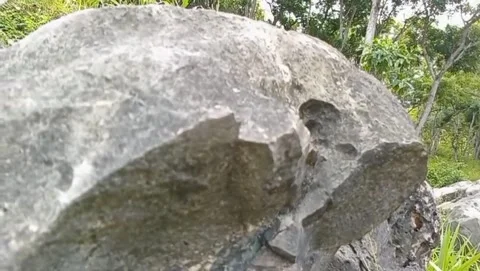 Large rocks with rough rock surfaces and natural holes. Stock Footage 325643747