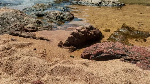 Large rocks surrounding a sandy beach, a beautiful wild beach. Stock Footage 320954924