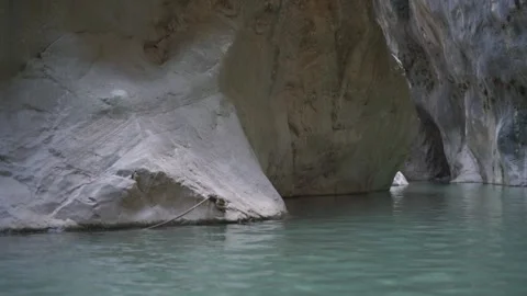 Large rocky cliffs of brown and grey colours located at lake Video stock 143340578
