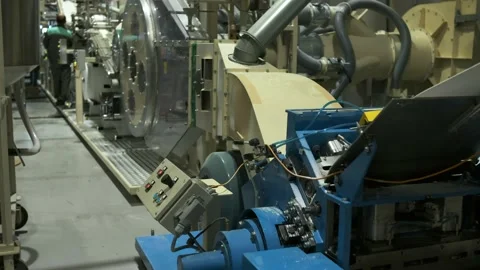 A large roll of cellulose, a material made of natural wood, rotates slowly on Stock Footage 163741631