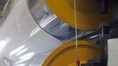 Large rollers and stripe of white polyester material closeup Stock Footage 105986702