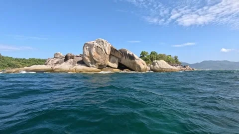 Large rolling waves crashing on breakwaters in the Adoman Sea at noon Stock Footage 339899066