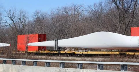 Large rotor for windmill on a train flatbed Stock Photos