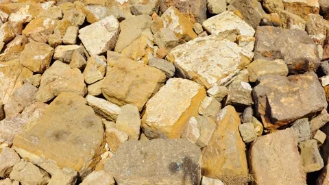 Large rough rocks and natural stone blocks in warm brown, beige and ochre tones Stock Footage 341952543