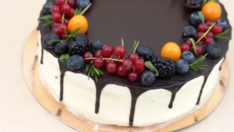 A large round cake is decorated with fresh berries. Vertical wiring Stock Footage 138792496