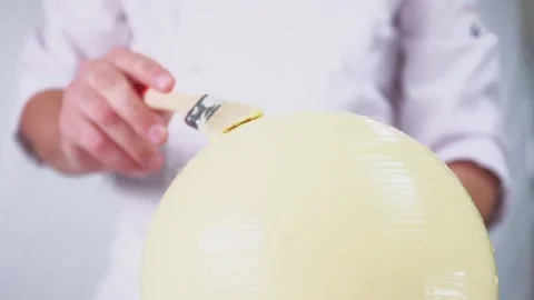 Large round dessert made of white chocolate with berry filling inside. Stock Footage 141561879