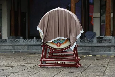 Large round drum covered with protective cloth on a red stand in a stone co.. Stock Photos