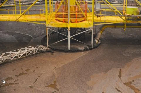 Large round floatation machine tank full of liquid at plant Stock Photos