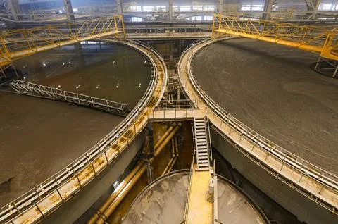 Large round floatation machine tank full of liquid at plant Stock Photos