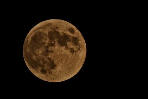 A large, round moon is in the sky Stock Photos