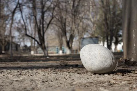 A large round stone on the ground Stock Photos