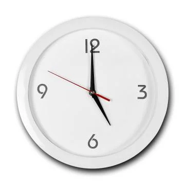 Large round white wall clock with white frame. The hands point to 5 o'clock.  Fotos Stock