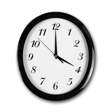 Large round white wall clock with black frame. The hands point to 4 o'clock.  스톡 사진