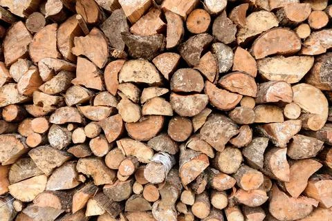Large rural stack of firewood. Old firewood. Background. Stock Photos