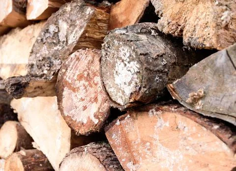 Large rural stack of firewood. Old firewood. Background. Stock Photos