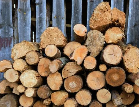 Large rural stack of firewood. Old firewood. Background. Stock Photos