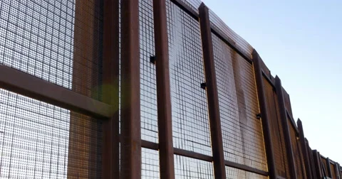 A Large Rusted Metal Wall Separating Two Countries Stock Footage 67652719