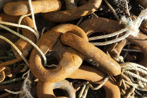 Large rusting fishing boat chain links on the harbour side at Gairloch, Wester Stock Photos