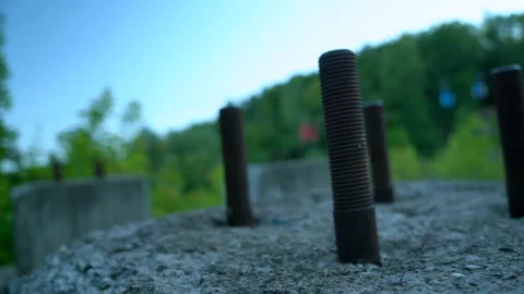 Large rusty mounting bolts from a destroyed building Stock Footage 158446618