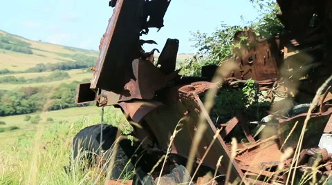 Large rusty vechicle behind long grass 4 Stock Footage 40718509