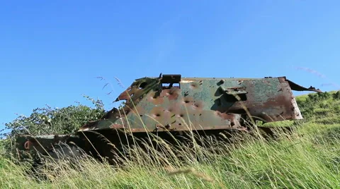 Large rusty vechicle behind long grass 7 bullet holes Stock Footage 40719994