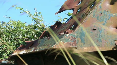 Large rusty vechicle behind long grass 9 Stock Footage 40720186