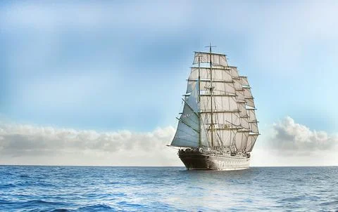 Large sailing ship navigating calm ocean under cloudy sky Stock Photos