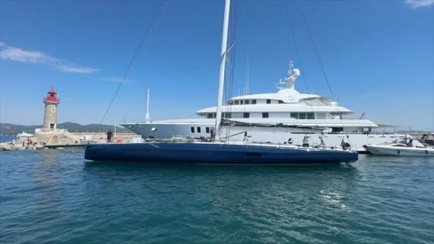 Large Sailing Yacht Passing Saint Tropez Harbor Lighthouse 스톡 동영상 337026189