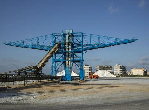 Large salt harvesting conveyor structure near salt piles and buildings in S.. Foto stock