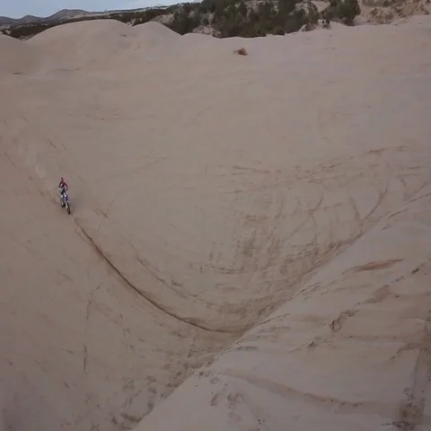 Large Sand Dune Jump on Dirt Bike HD Stock Footage 69528079