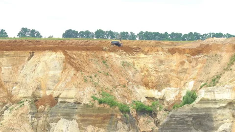 A large sand pit the sand is mined on an industrial scale. Stock Footage 146103136