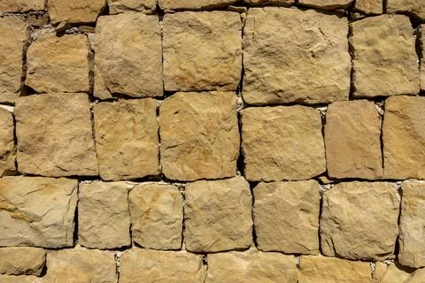 Large sandstone block patterned brick wall closeup Stock Photos