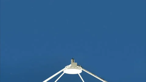 Large Satellite Dish Pointing Blue Sky Stockbeeldmateriaal 135997659