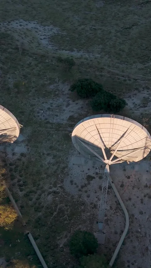Large satellite dish slowly rotating at sunset Stock Footage 290449691