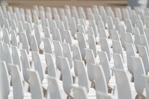 Large scale seating setup with many chairs prepared for an audience in a bi.. Photos
