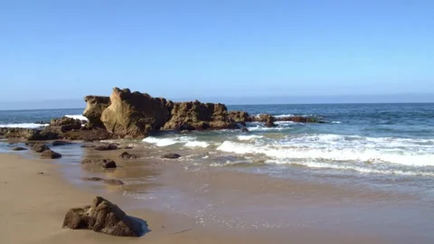 Large Scenic Rock With Waves Rolling In on the Beach Stock Footage 171400796