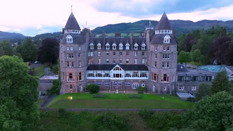 A large Scottish building with a tower and a green roof Stock Footage 306624581